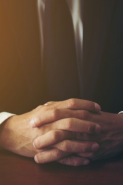 lawyer with hands folded at desk bronx ny