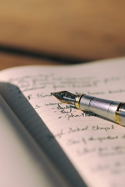 pen laying in notepad with writing queens ny